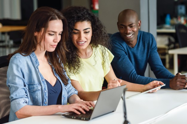 multi-ethnic-group-of-young-people-studying-with-laptop-computer_1139-984